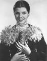 Publicity shot for Paddy O'Day, here she is shown holding the 'Rita Cansino' dahlias, so named by Mrs. G. F. Stephenson of the 'Dahlia Society of America'
